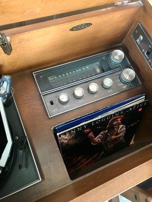 A vintage record and stereo system complete with albums