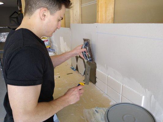 Nick learning to tile a backsplash Home Repair Lab.