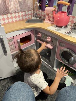 My granddaughter loves the little kitchen play area.