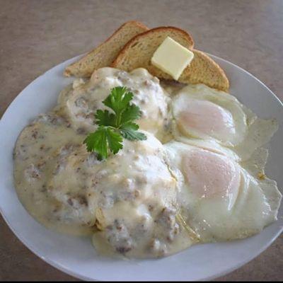 Homemade sausage gravy and biscuits with perfectly fried over medium eggs