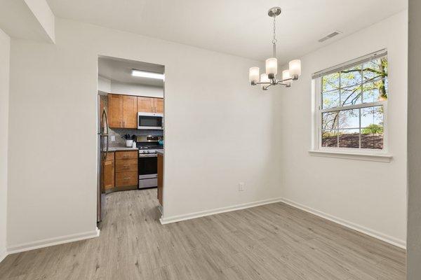 Luxury plank flooring flows from the dining room into the kitchen.