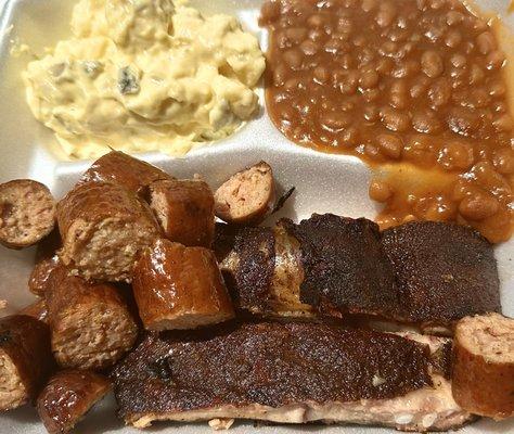 Combo dinner with ribs, sausage, potato salad and baked beans