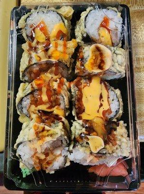 Volcano Roll: tuna, cucumber & crab meat; deep fried with spicy mayo & eel sauce & sriracha sauce on top