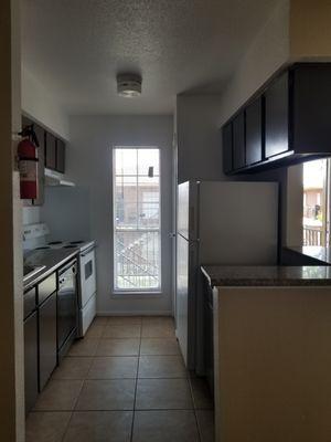 Kitchen has granite counter top and ceramic title floors  We invite you to come and take a tour of out property .