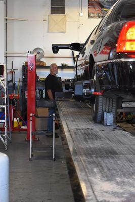 Car on a lift inside the shop