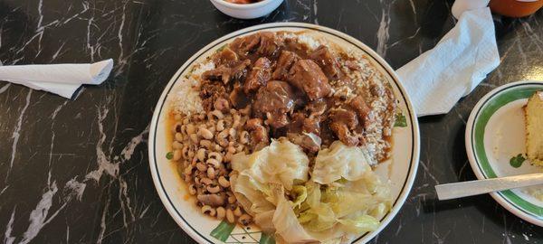 Cabbage, blackeye peas over rice, rice and gravy with oxtails