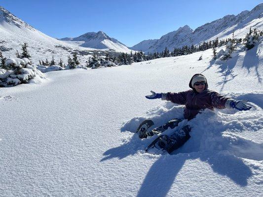 Make a snow angel on one of our snowshoeing tours!