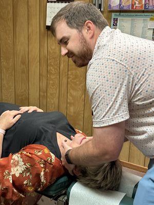 Doctor Holladay adjusting a patient with neck pain