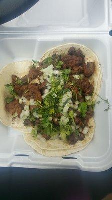 Carne asada tacos to go! LOTS of meat  So delicious! Well seasoned! Ask for the green sauce if you can handle some heat!