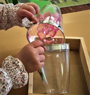 Independent learning of pouring to foster focus, hand-eye coordination and preparation for pouring their own water at snack time