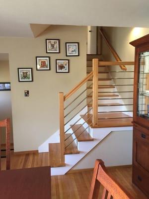 Contemporary stair railing w/ horizontal stainless steel rods.