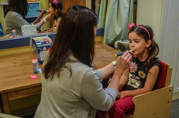 Melanie demonstrates an oral motor therapy session with Hayden.