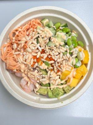 Create a bowl with shrimp and crab salad over white sushi rice.  Avocado, mango, edamame, masago and crispy rice.