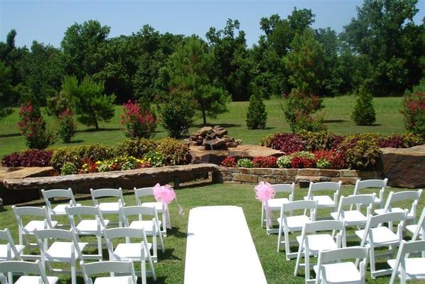 Rock flower beds with small waterfall