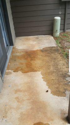 Water leaking out of the storm door after apartment flooded by upstairs unit