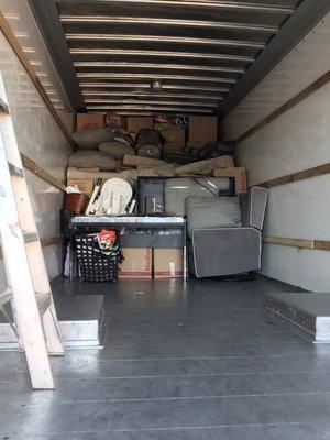 Loading a 26ft truck with furniture and boxes of a 2 bedroom house.