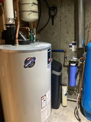 New water heater with thermal expansion tank on code approved hanger and auto flood stop valve