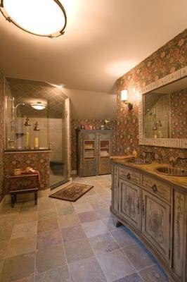 Bath design showcasing old world charm and rustic slate floors highlighted by hand painted walllcovering