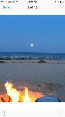 The warmth of the bonfire and the beauty of the full moon rising over the ocean.