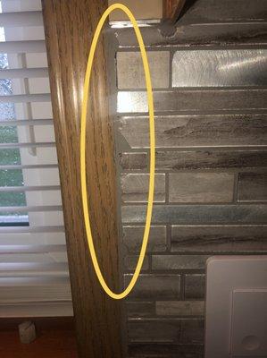 Owner installed chipped up glass tile even leaving a black marker cutting line behind.  His excuse was that he filled it with grout.