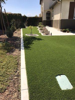 American made Greenridge installed in the Jurupa Valley with curbing and Arizona River rock.