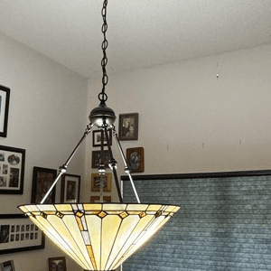 Stained glass pendant light
Vintage chandelier installation
Art Deco lighting fixture