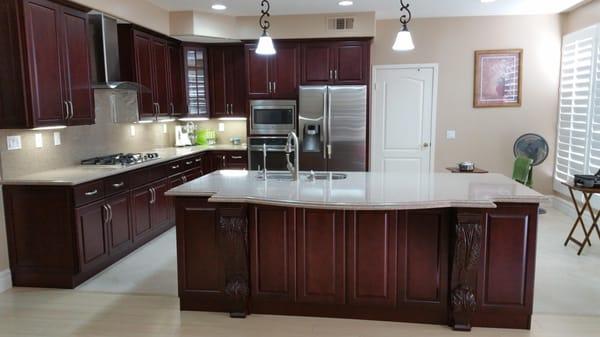 Creative in House Kitchen Design's.  Dark Cherry Cabinets & Quartz Counter Tops With Full Quarts Back Splash