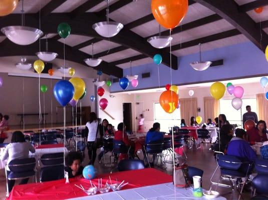 Hall decorated with balloons for a bday party