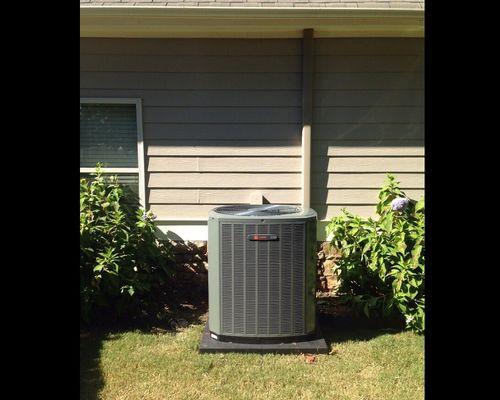 New Trane AC unit with new copper lineset covered in a downspout to match the home