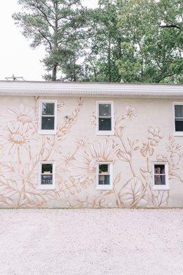 Side of the building with gravel lot.