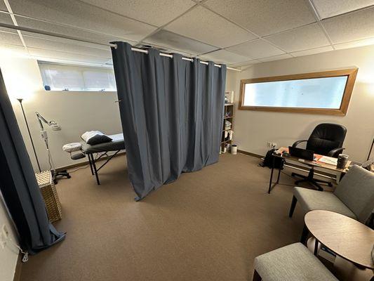 Office/consultation area separated from the treatment area with blackout curtains for patient privacy.