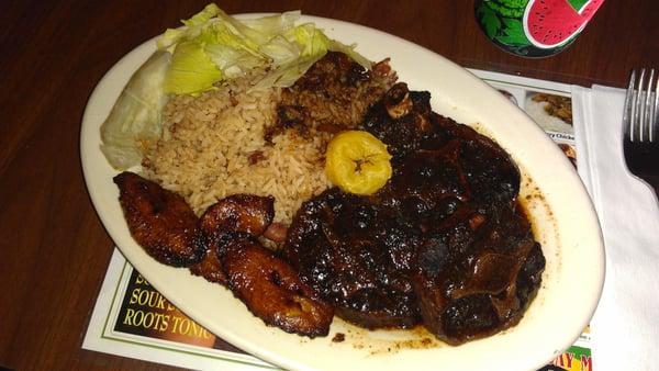 Oxtail, broen rice with pigeon peas, sweet plantain, yuca and marinated onions... Gotta try