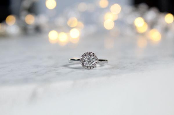 Classic round diamond engagement ring with a halo of diamonds