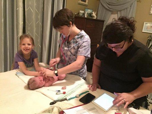 Siblings love to help with the newborn exam at home births.