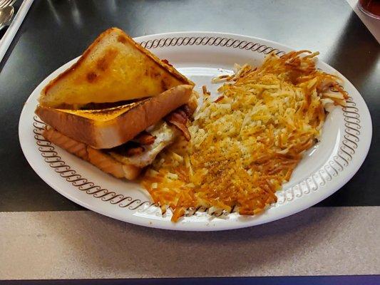 The egg, bacon, cheese sandwich on texas toast with hashbrowns.