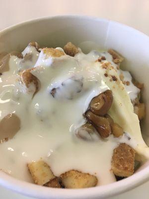 Eggnog and Peanut Butter yogurt, with wet walnuts, Reece's cups, cheesecake bites, and marshmallow sauce