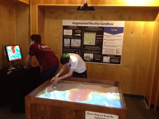 Ultra-cool sandbox with topographical projector. Create your own world, see the geographical effects change.