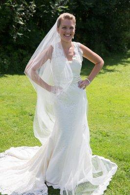 Lace bridal gown and veil with lace trim