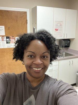 Me (on a rough hair day lol) inside a patient room at Novant Health Forsyth Family Medicine.