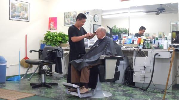 Aaron giving George a haircut.