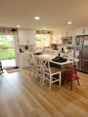 Kitchen: wall taken down, new cabinets counters and appliances, can lighting installed and flooring