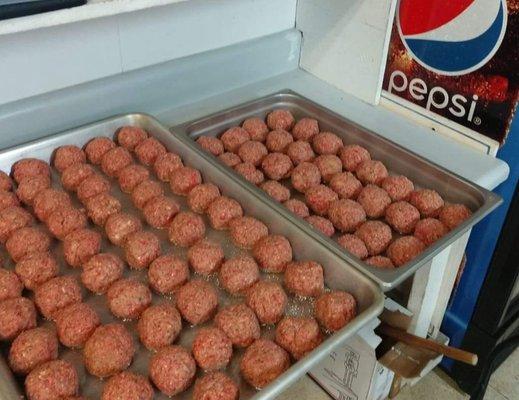 Fresh meatballs getting ready to cook.