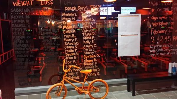 Weight loss competition wall. Love the orange bike