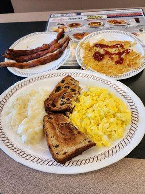 Eggs, grits, hashbrowns, bacon, and raisin toast.