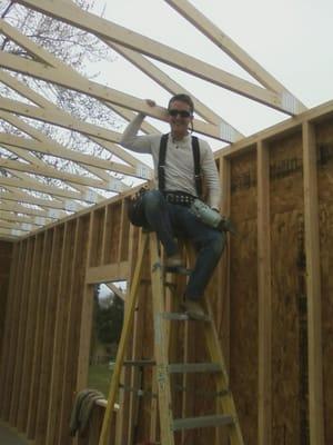 Blake doing framing work on a garage.