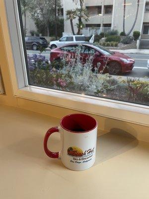 Enjoying coffee while enjoying view from bay window.