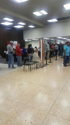 The line is backed up all the way to the entrance of the bank.