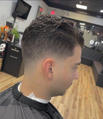 Low Fade, scissors on top. 

Morris Ave Barbers 
1561 B Morris Ave 
Union NJ, 07083