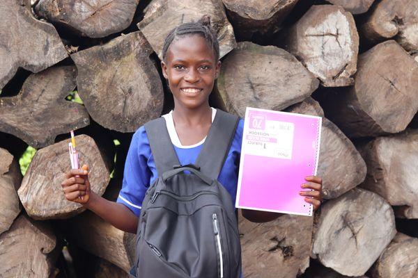 student with backpack and school supplies