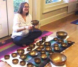 Mary Ann Gebhardt  with her Tibetan singing bowls conducting a yoga nidra session.